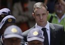 Oscar Pistorius escorted by police officers leaves the high court in Pretoria, South Africa, Friday, Oct. 17, 2014. Following the testimony hearing, Judge Thokozile Masipa is expected to announce Pistorius' sentence on Tuesday after she found him guilty last month of culpable homicide for negligently killing Steenkamp, but acquitted him of murder. (AP Photo/Themba Hadebe)