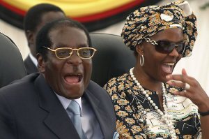 Zimbabwe first lady Grace Mugabe (R) and her beau President Mugabe enjoy a hearty moment