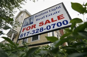 This July 10, 2014 file photo shows a home for sale in Quincy, Mass. Freddie Mac reports on average U.S. mortgage rates for the week on Thursday, Oct. 16, 2014. (AP Photo/Michael Dwyer, File)