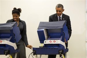 In this photo taken Oct. 20, 2014, President Barack Obama votes next to Aia Cooper at the Dr. Martin Luther King Community Service Center in Chicago. As Cooper was voting next to Obama her boyfriend, Mike Jones, decided to crack wise: "Mr. President, don't touch my girlfriend." Obama, laughing, replied: "There's an example of a brother just embarrassing me for no reason."  (AP Photo/Evan Vucci)