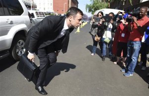 Oscar Pistorius adjusts trouser as he arrives at the high court in Pretoria, South Africa, Friday, Oct. 17, 2014. Following the testimony hearing, which is expected to end this week, Judge Thokozile Masipa will rule on what punishment Pistorius must serve after convicting him of culpable homicide for shooting his girlfriend Reeva Steenkamp through a toilet door in his home. (AP Photo)
