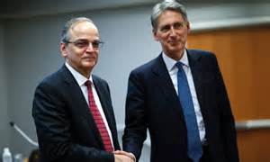 Hammond shakes hands with Syrian National Coalition President Hadi
