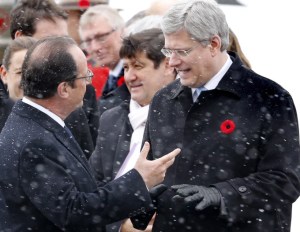 French President Francois Hollande, left, talks with Canadian Prime Minister Stephen Harper as he arrives in Canada for a state visit in Calgary, Alberta on Sunday, Nov. 2, 2014. 