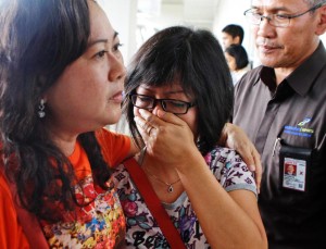 A relative of AirAsia flight QZ 8501 passengers weep as she waits for thelatest news on the missing jetliner at Juanda international Airport in Surabaya.Dec 28 2014.