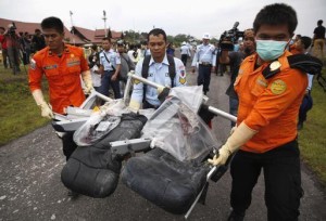 Parts of AirAsia QZ8501, recovered from the Java Sea, are carried by Indonesian Airforce