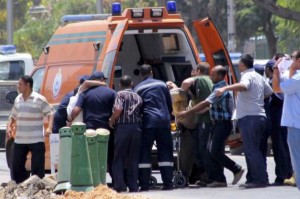 File-People injured in bomb blasts are transported to an ambulance in Cairo June 30, 2014