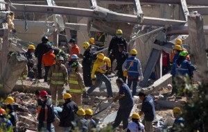 Rescue workers comb through the rubble of a children's hospital after a gas truck exploded, in Cuajimalpa on the outskirts of Mexico City, Thursday, Jan. 29, 2015. The powerful explosion shattered the hospital on the western edge of Mexico's capital, killing at least three adults and one baby and injuring dozens.