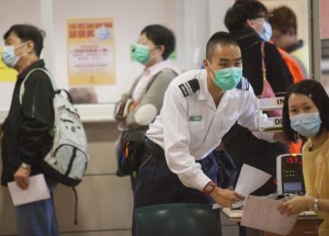 Patients wear face masks to protect themselves against the flu at a hospital in Kowloon.
