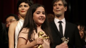 Hana Saeidi, niece of absent Iranian Director Jafar Panahi, holds the Golden Bear for the best Film for 'Taxi' she received on his behalf during the award ceremony at the 2015 Berlinale Film Festival in Berlin, Germany, Saturday, Feb. 14, 2015. 