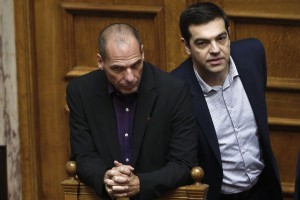 Greek Minister Alexis Tsipras left, chats with his Finance Minister Yanis Varoufakis,