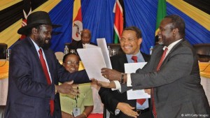 President Kiir signs cessation of Hostilities agreement with Rebel Leader Riek Machar. H.E Kiir exchanges a copy of the signed agreement with Machar