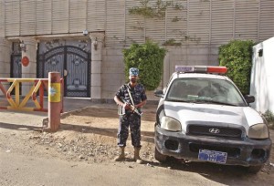 A member of the Yemeni security forces stands guard outside the Turkish embassy in Sanaa after it closed following security concerns on Feb 15.