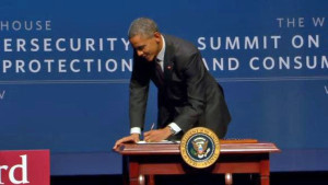 President Barack Obama signs a cybersecurity-focused executive order at Stanford University, Friday, Feb. 13, 2015. 