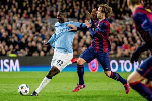 Ivan Rakitic of Barcelona (R) vies with Yaya Toure of Manchester City (L) during the UEFA Champions League round of 16 match between FC Barcelona and Manchester City at Camp Nou Stadium in Barcelona, Spain on March 18, 2015.