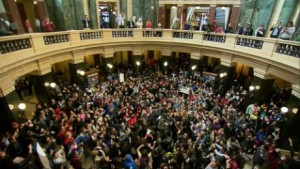 As protesters storm the Madison capitol in Wisconsin over the shooting death of a teenager,