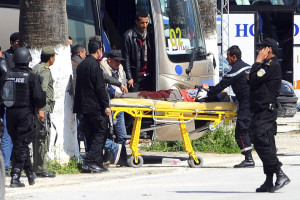 A victim is being evacuated from the Bardo museum are evacuated in Tunis, Wednesday, March 18, 2015 in Tunis, Tunisia after gunmen opened fire at the leading museum in Tunisia's capital. Tunisia's prime minister says 21 people are dead after an attack on a major museum, including 17 foreign tourists ó and that two or three of the attackers remain at large.