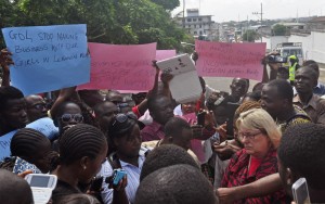 U.S Embassy representative Sally Hodgson, right, collects a petition during a protest near the U.S Embassy in Monrovia, Liberia, Tuesday, April 28, 2015. Protesters gathered Tuesday in front of the U.S. Embassy in Liberia’s capital, asking the government to put pressure on Liberian officials to bring back some 60 Liberian young women allegedly trafficked into Lebanon between 2011 and 2012. U.S. Embassy Public Affairs director Sally Hodgson said the embassy received the petition and they were already engaged with the Liberian authorities. 