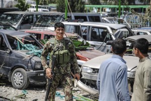 Members of the Afghan security forces inspect the site of a suicide bomb attack targeting a convoy of U.S. forces near Nangarhar airport, which is used as a U.S. military base, in Jalalabad, the capital of eastern Nangarhar province, Afghanistan on April 10, 2015. At least four civilians have been killed and 13 others wounded after a suicide bomber detonated his explosive near a convoy carrying U.S. forces in Afghanistan`s Nangarhar province.