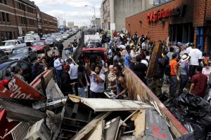 People work to clean up a looted and burned CVS store in Baltimore