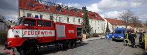 A fire truck is seen in front of a building damaged in an apparent arson attack in Tröglitz, Germany. Some 40 refugees were to be provided with accomodation in the building starting in mid-May.