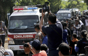 Members of the media photograph a convoy of ambulances as they arrive at Wijayapura ferry port to cross to the prison island of Nusakambangan, in Cilacap, Central Java, Indonesia, Tuesday, April 28, 2015. Indonesia notified nine foreigners and a local man convicted of drug trafficking over the weekend that their executions will be carried out within days, ignoring appeals by the U.N. chief and foreign leaders to spare them. 