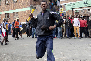A man armed with a hatchet threatens members of the press in Johannesburg after overnight violence between locals and immigrants in Johannesburg. Several shops and cars were torched overnight in continued anti-immigrant attacks by locals.