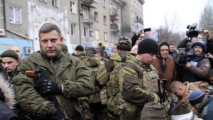Ukrainian rebel leader Alexander Zakharchenko (left) stands next to kneeling captive soldiers in Donetsk