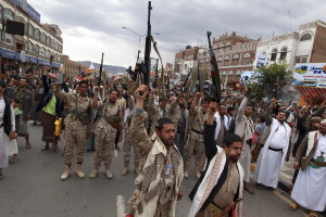Shiite rebels, known as Houthis, hold up their weapons to protest against Saudi-led airstrikes, as they chant slogans during a rally in Sanaa, Yemen, Thursday, March 26, 2015. Saudi Arabia bombed key military installations in Yemen on Thursday, leading a regional coalition in a campaign against Shiite rebels who have taken over much of the country and drove out the president.