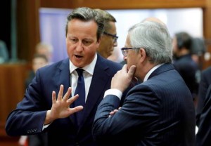 British Prime Minister David Cameron, left, speaks with European Commission President elect Jean-Claude Juncker during a round table meeting at an EU summit in Brussels