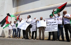  A group of journalists stage a demonstration to protest Israel's violence to press members ahead of the occasion of the World Press Freedom Day in Bethlehem, West Bank on May 02, 2015. Some protesters got injured due to interference of Israeli security forces during demonstration.