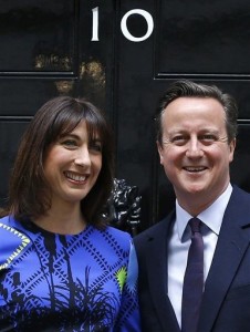 Britain's Prime Minister David Cameron and his wife Samantha wave from the steps of 10 Downing Street in London Friday, May 8, 2015 after meeting Britain's Queen Elizabeth II where he informed her that he has enough support to form a government. The Conservative Party swept to power Friday in Britain's Parliamentary elections winning an unexpected majority