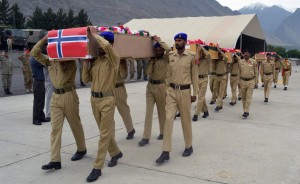 Pakistani soldiers carry the caskets of victims of a helicopter crash to a military plane prior to their transport to Islamabad, at the small domestic airport of Gilgit, in the Gilgit-Baltistan region of Pakistan, Saturday, May 9, 2015. The helicopter, transporting dignitaries to a ceremony at a ski resort, crashed and caught fire as it was landing on Friday killing seven people including ambassadors from the Philippines and Norway and the wives of the ambassadors from Malaysia and Indonesia
