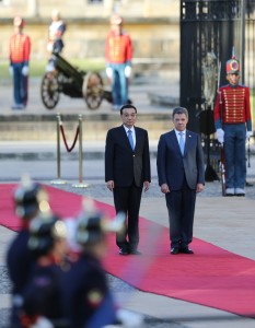 China's Premier Li Keqiang, left, and Colombia's President Juan Manuel Santos, right, receive military honors before they review the troops during a welcoming ceremony at the Presidential Palace in Bogota, Colombia, Thursday, May 21, 2015. Li Keqiang is in Colombia in an official two-day visit and will then tour Peru and Chile.