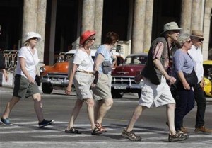 In this March 13, 2015 file photo, tourists cross traffic lights in Havana, Cuba. Tourists in shorts and sandals aren\'t the only foreigners flooding Havana these days. Top diplomats from Japan, the European Union, Italy, the Netherlands and Russia have visited the island in recent months in a bid to stake out or maintain ties with an island that suddenly looks like a brighter economic prospect amid warming U.S.-Cuba relations. 