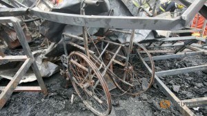 A burnt-out wheelchair is seen among the debris after a fire at a rehabilitation centre for the elderly in Sanlihe village of Pingdingshan, Henan province, China, May 26, 2015