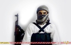 This image taken from a militant website associated with Islamic State extremists, posted Saturday, May 23, 2015, purports to show a suicide bomber identified as a Saudi citizen with the nom de guerre Abu Amer al-Najdi who carried out an attack on a Shiite mosque. The Islamic State group's radio station has claimed responsibility for that suicide bombing Friday, warning that more "black days" loom ahead for Shiites. The attack killed at least 21 people and wounded dozens in the village of al-Qudeeh in the eastern Qatif region as worshippers commemorated the birth of a revered saint. The Arabic bar below reads: "Urgent: The heroic martyr Abu Amer al-Najdi, the attacker of the (Shiite) temple in Qatif." 