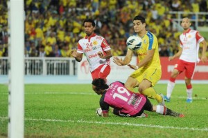 Pahang striker Matias Conti lifts the ball over Kelantan keeper Khairul Fahmi Che Mat to score the only goal in the FA Cup semi-final first leg match in Kuantan on Saturday.
