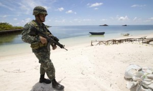 Filipino soldier patrols shore of Pag-asa island during the visit of Gen. Gregorio Pio Catapang.