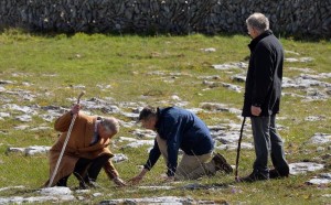 Britain's Prince Charles (L) and BurrenBeo Trust Project Manager Brendan Dunford (C) examine the flora during the prince's visit to Burren National Park in west Ireland, on May 19, 2015 