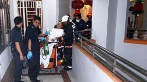 Singapore Civil Defence Force personnel wheeling the man out of his Jurong West Street flat after his right hand was stuck in the drainage trap of his master bedroom toilet 