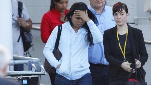 Febyanti Herewila (centre), the widow of convicted Bali Nine drug smuggler Andrew Chan, covering her face after arriving at the international airport in Sydney on May 2, 2015 