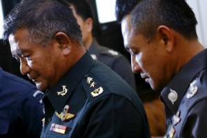 Thai Lieutenant General Manus Kongpan (L), a three-star Thai general accused of involvement in human trafficking, walks at the National Police Headquarters as he turns himself in to the authorities in Bangkok June 3, 2015.   