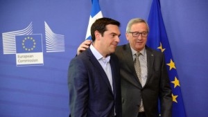 Greek Prime Minister Alexis Tsipras (L) walks with European Union Commission President Jean-Claude Juncker prior to a meeting at the European Union Commission headquarter in Brussels, on June 3, 2015