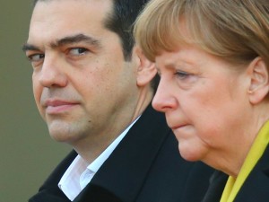 German Chancellor Angela Merkel and Greek Prime Minister Alexis Tsipras listen to their countries' national anthems upon his arrival for talks at the Chancellery on March 23, 2015 in Berlin, Germany. 