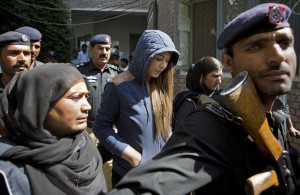 Pakistan's top model, Ayaan Ali, center, arrives in tight security to appear in a court in Rawalpindi, Pakistan, Monday, June 1, 2015. Ali is under detention since her midnight arrest on March 14 at Islamabad airport and faces money laundering charges after authorities seized over $500,000 before she boarded a Dubai-bound flight. Pakistani law makes it illegal for a passenger carry over $10,000 on a flight. 