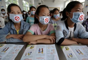 Students wearing masks with no smoking signs attend an anti-smoking lecture ahead of the World No Tobacco Day, at a middle school in Fuyang, Anhui province, China, May 29, 2015. World No Tobacco Day falls on May 31 every year. Picture taken May 29, 2015. 