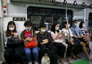 Passengers wearing masks to prevent contracting Middle East Respiratory Syndrome (MERS) sit inside a train in Seoul, South Korea. the country is the second in the world to report large number of cases of MERS following Saudi Arabia.