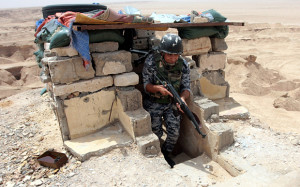 An Iraqi soldier stands guard at a military barracks near Ramadi city, western Iraq