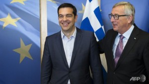 Greece's Prime Minister Alexis Tsipras (L) is welcomed by European Commission President Jean-Claude Juncker (R) ahead of a meeting on Greece, at the European Commission in Brussels.
