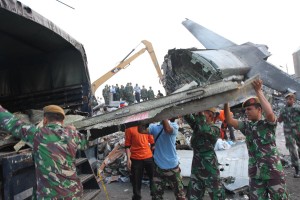  Indonesia military forces and rescue teams clean the wrecked pieces of the Indonesian military plane after the Indonesian military plane crashed in Medan, North Sumatra, Indonesia on July 1, 2015. An Indonesian air force cargo plane crashed shortly after take-off Tuesday into a busy residential area of North Sumatra's provincial capital, leaving at least 113 people were killed according to the head of Indonesia's Air Force staff has said.